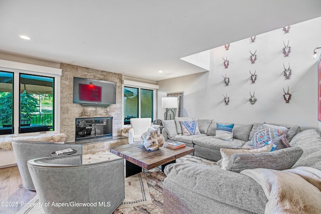 52 Harleston Grn Unit 38, Snowmass Village, CO 81615 - living room featuring wood finished floors, a stone fireplace, and recessed lighting