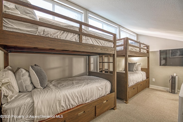 52 Harleston Grn Unit 38, Snowmass Village, CO 81615 - bedroom with carpet, vaulted ceiling, and a textured ceiling