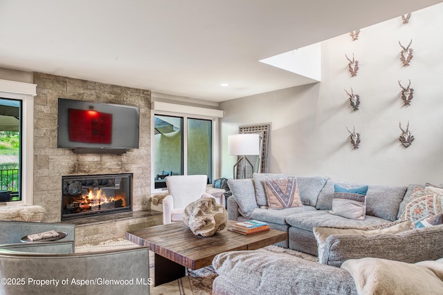 52 Harleston Grn Unit 38, Snowmass Village, CO 81615 - living area with a fireplace and plenty of natural light