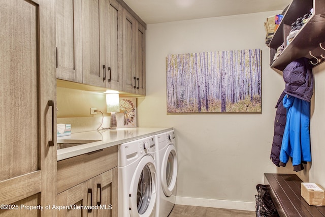 52 Harleston Grn Unit 38, Snowmass Village, CO 81615 - washroom featuring separate washer and dryer and cabinet space