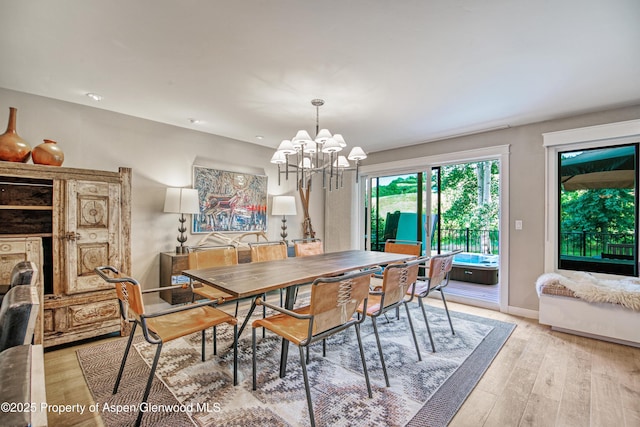52 Harleston Grn Unit 38, Snowmass Village, CO 81615 - dining space with a chandelier and light wood-type flooring