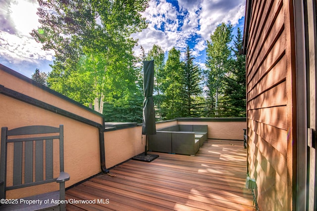 52 Harleston Grn Unit 38, Snowmass Village, CO 81615 - wooden deck with view of scattered trees
