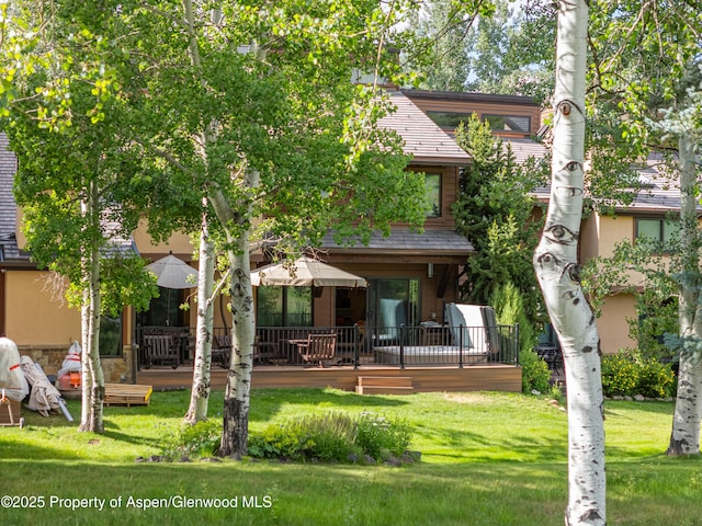 52 Harleston Grn Unit 38, Snowmass Village, CO 81615 - rear view of property with a lawn, a deck, and stucco siding