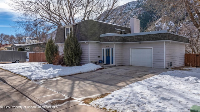 view of front of home featuring a garage and a mountain view