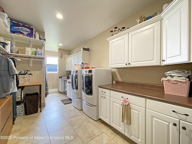 laundry room featuring cabinet space, independent washer and dryer, light tile patterned floors, and recessed lighting