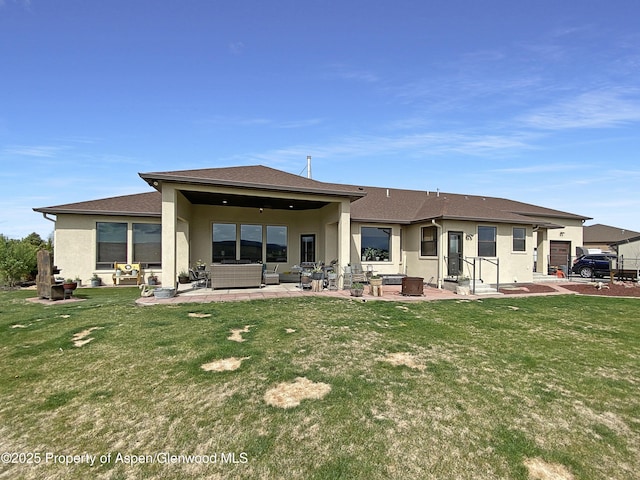 back of property featuring stucco siding, a patio area, a yard, and outdoor lounge area