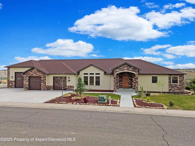 ranch-style house featuring stone siding, stucco siding, an attached garage, driveway, and a front lawn