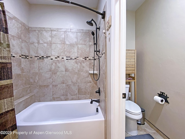 bathroom featuring toilet, shower / tub combination, and baseboards