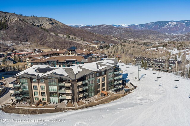 snowy aerial view featuring a mountain view