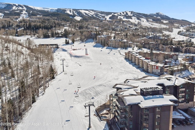 snowy aerial view with a mountain view