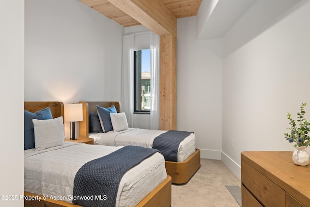 bedroom with wooden ceiling, beamed ceiling, baseboards, and light carpet