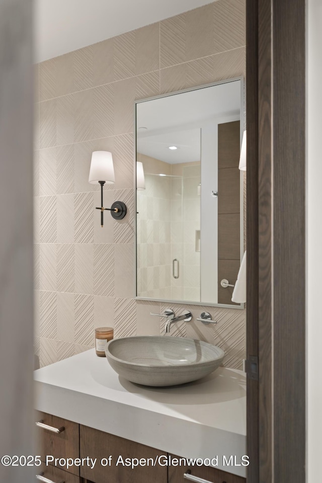 bathroom featuring vanity and a shower stall