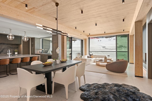 dining area featuring wooden ceiling, floor to ceiling windows, and light tile patterned floors