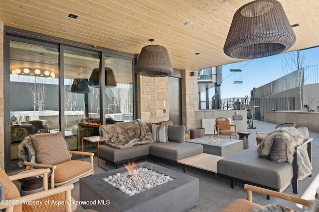 view of patio featuring an outdoor living space with a fire pit