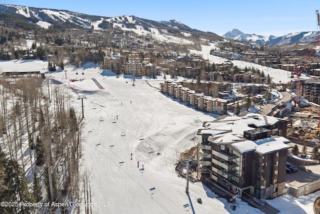 snowy aerial view featuring a mountain view