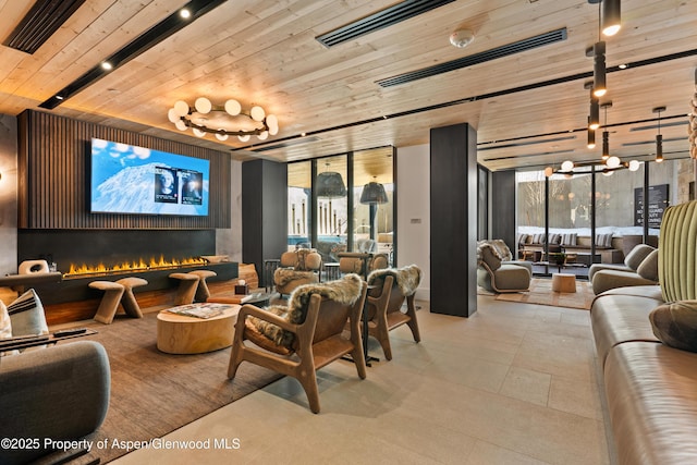 home theater featuring visible vents, a healthy amount of sunlight, wood ceiling, and a lit fireplace