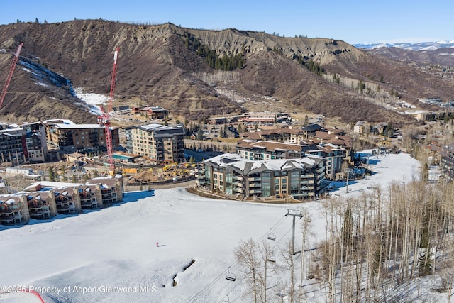 snowy aerial view with a mountain view