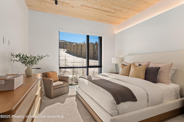 bedroom with wooden ceiling and carpet