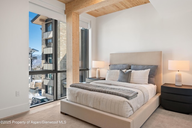 bedroom featuring beam ceiling and wood ceiling