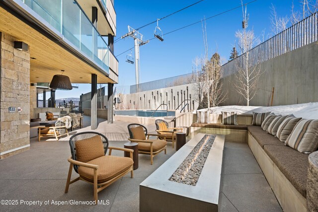 view of patio / terrace featuring an outdoor living space with a fire pit and a fenced backyard