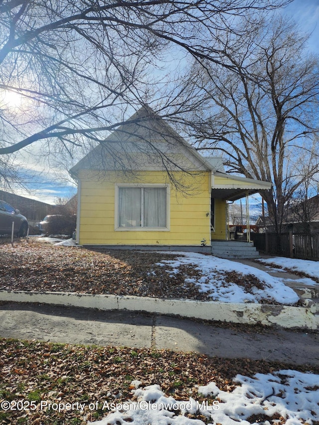 snow covered property with a porch