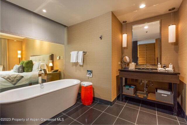 bathroom featuring tile patterned floors, a tub, and vanity