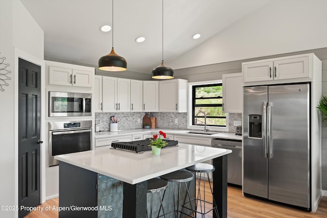248 Basalt Mountain Dr, Carbondale, CO 81623 - kitchen with stainless steel appliances, backsplash, white cabinets, recessed lighting, and lofted ceiling
