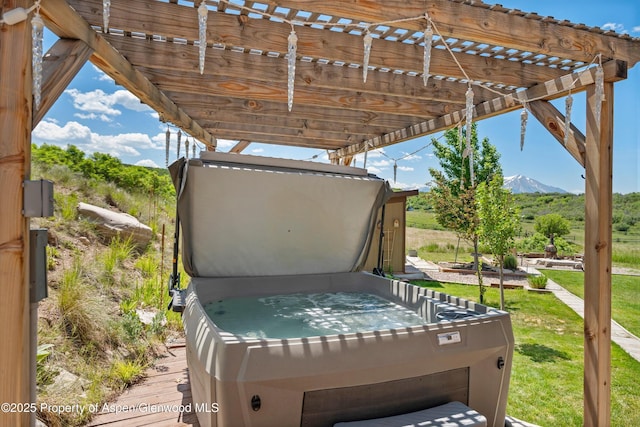 248 Basalt Mountain Dr, Carbondale, CO 81623 - deck featuring a hot tub, a mountain view, a pergola, and a lawn