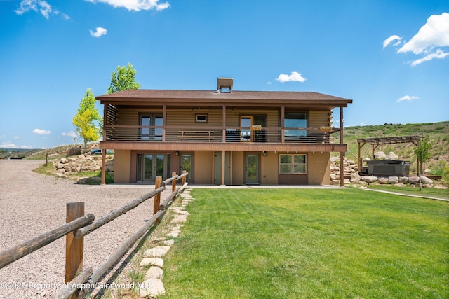 248 Basalt Mountain Dr, Carbondale, CO 81623 - back of house featuring log exterior, a lawn, a patio, a balcony, and stucco siding