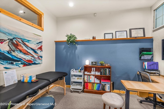 carpeted office space featuring baseboards