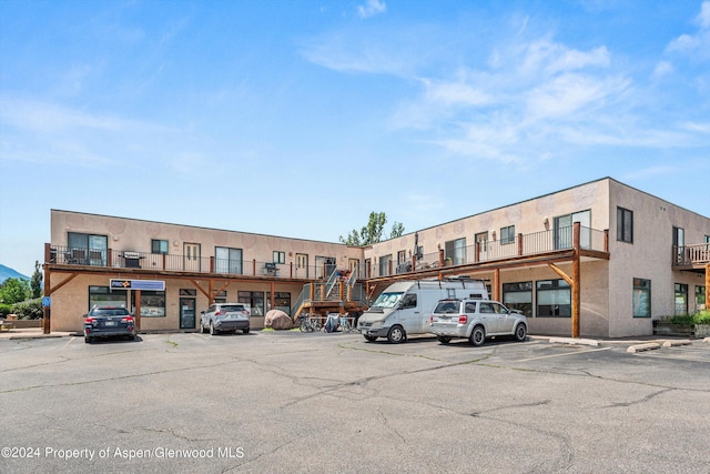 view of building exterior featuring uncovered parking