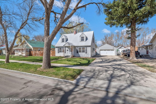 668 Taylor St, Craig, CO 81625 - cape cod-style house featuring a garage, metal roof, concrete driveway, a front yard, and an outbuilding
