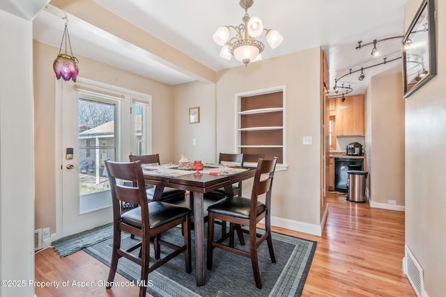 668 Taylor St, Craig, CO 81625 - dining space with light wood finished floors, baseboards, a chandelier, and visible vents