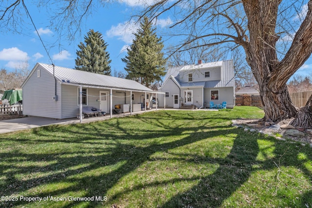 668 Taylor St, Craig, CO 81625 - back of house featuring metal roof, fence, and a yard