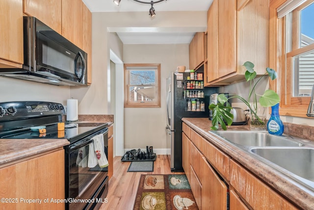 668 Taylor St, Craig, CO 81625 - kitchen featuring black appliances, light countertops, light wood finished floors, and a sink