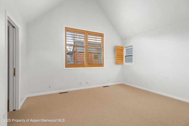 interior space with lofted ceiling, baseboards, and visible vents