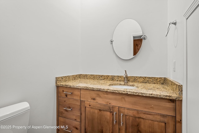 bathroom featuring vanity and toilet