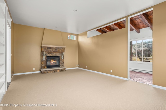 unfurnished living room with a wealth of natural light, carpet flooring, and baseboard heating