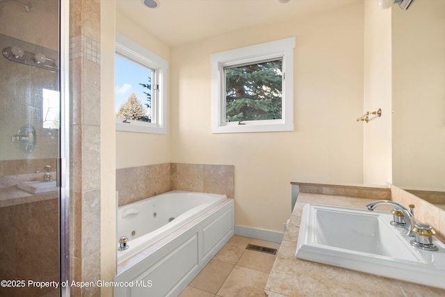 bathroom featuring visible vents, a whirlpool tub, tile patterned flooring, a shower stall, and a sink