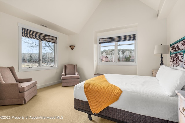 bedroom featuring baseboards, high vaulted ceiling, multiple windows, and light colored carpet