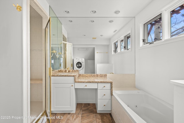 full bathroom featuring recessed lighting, washer / clothes dryer, a stall shower, vanity, and a tub with jets