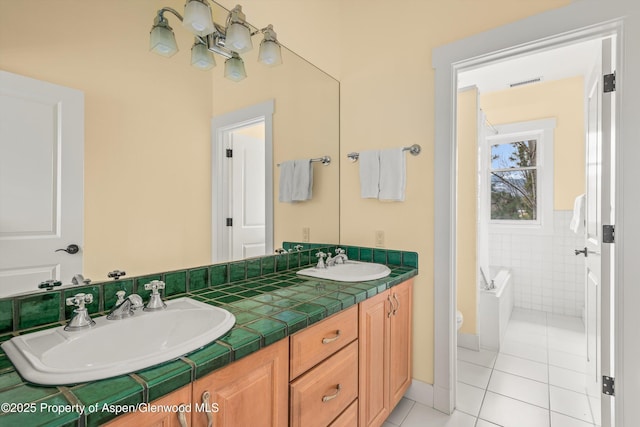 full bath with visible vents, a sink, tile walls, and tile patterned floors