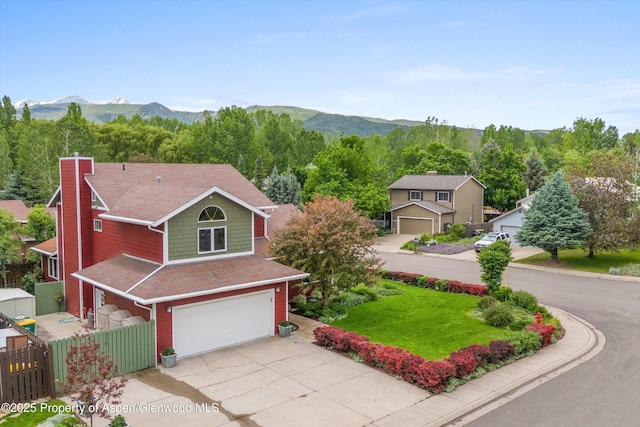 309 Deer Run, Carbondale, CO 81623 - view of front of house featuring a garage, driveway, a mountain view, and a chimney