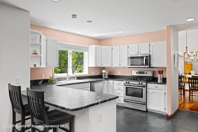 309 Deer Run, Carbondale, CO 81623 - kitchen with appliances with stainless steel finishes, a peninsula, dark countertops, white cabinetry, and recessed lighting