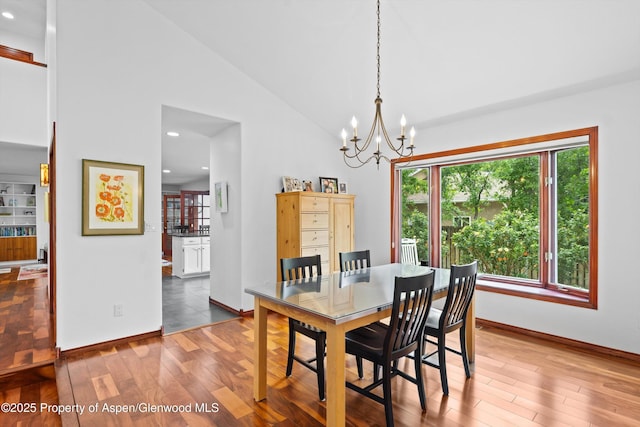 309 Deer Run, Carbondale, CO 81623 - dining area with wood finished floors, a chandelier, recessed lighting, and high vaulted ceiling