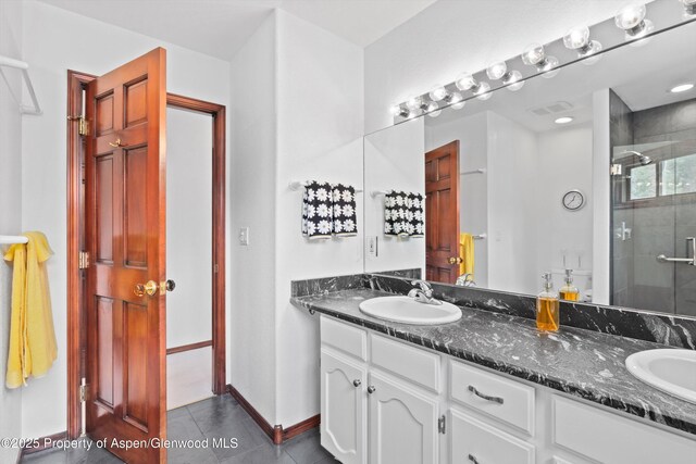309 Deer Run, Carbondale, CO 81623 - full bath featuring double vanity, a stall shower, and tile patterned flooring