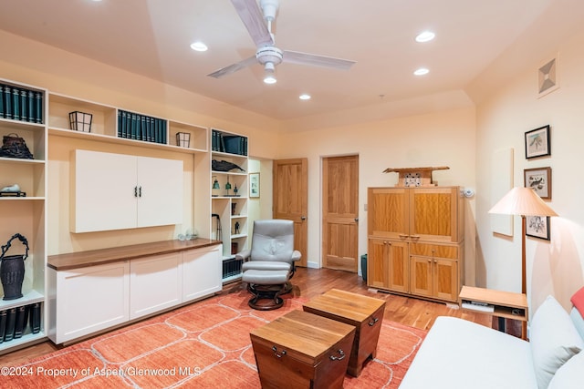 living room featuring hardwood / wood-style floors and ceiling fan