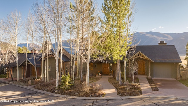 view of front facade featuring a mountain view and a garage