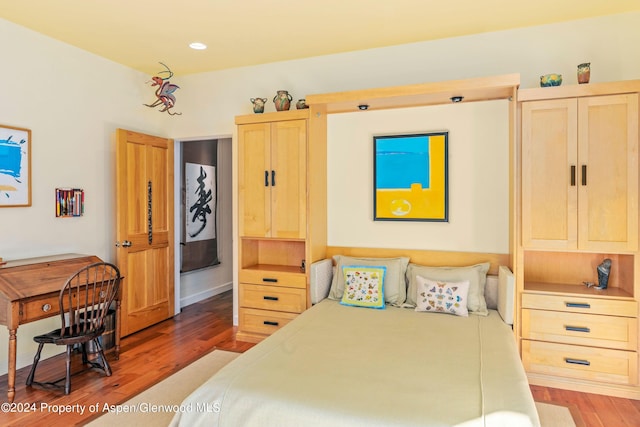 bedroom with hardwood / wood-style floors