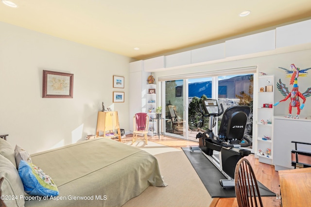 bedroom with access to exterior and light hardwood / wood-style flooring